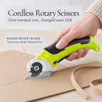 Cordless rotary scissors cutting along a pencil line on kraft cardboard